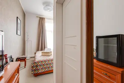a living room with a tv and a couch at Kafka Prague rooms in Prague