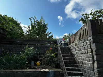 a brick retaining wall with a set of stairs at Byt v rezidenční čtvrti Prahy 6 in Prague