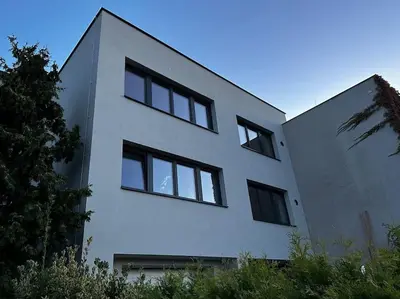 a white building with black windows on the side of it at Byt v rezidenční čtvrti Prahy 6 in Prague