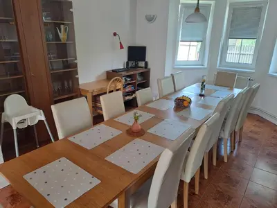 a dining room with a wooden table and chairs at Wellness Villa Vranov 55 in Čerčany
