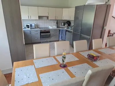 a kitchen with a table with chairs and a dining room at Wellness Villa Vranov 55 in Čerčany