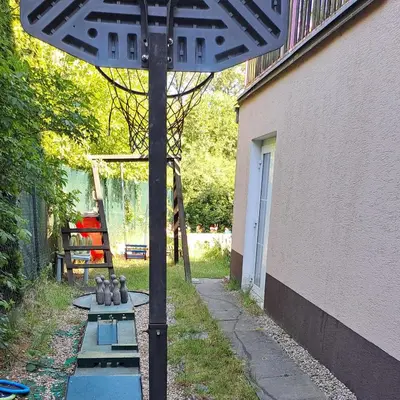 an umbrella in a yard next to a building at Wellness Villa Vranov 55 in Čerčany