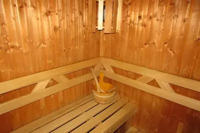 a inside of a wooden sauna with a bucket at Wellness Villa Vranov 55 in Čerčany