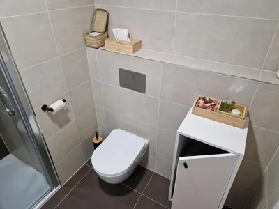a small bathroom with a toilet and a sink at Prague City Center Apartment in Prague