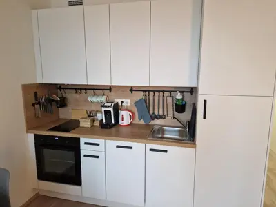 a kitchen with white cabinets and a sink at Prague City Center Apartment in Prague