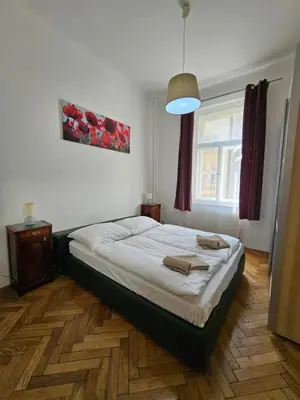 a bedroom with a bed and a window at Slezska Apartments in Prague