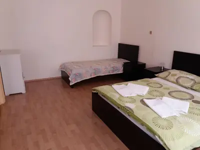 a room with two beds and two tables in it at Apartments Tronicek in Prague