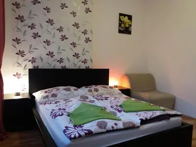 a bedroom with a bed with a flowery wallpaper at Apartments Tronicek in Prague