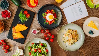 a wooden table with plates of food on it at Residence Dvorak in Prague