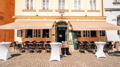a restaurant with tables and chairs in front of a building at Residence Dvorak in Prague
