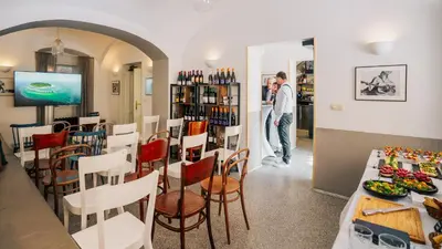a man standing in a restaurant with a table and chairs at Residence Dvorak in Prague