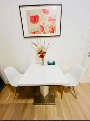 a white table with two chairs and a vase with flowers at NEW DESIGN & STYLE Apartments 50m from Wenceslas Square in Prague