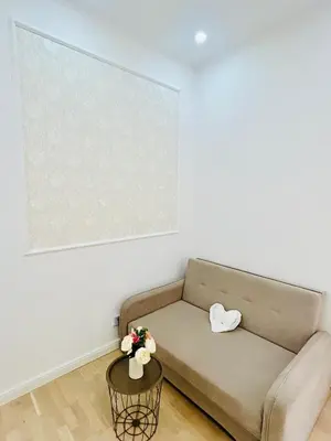 a living room with a couch and a large picture at NEW DESIGN & STYLE Apartments 50m from Wenceslas Square in Prague