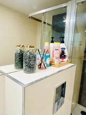 a counter with bottles of soap and other products on it at NEW DESIGN & STYLE Apartments 50m from Wenceslas Square in Prague