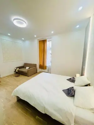 a bedroom with a large white bed and a couch at NEW DESIGN & STYLE Apartments 50m from Wenceslas Square in Prague