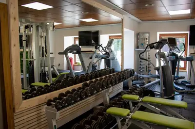 a gym with a row of exercise bikes at Kokořín Apartments in Kokořín