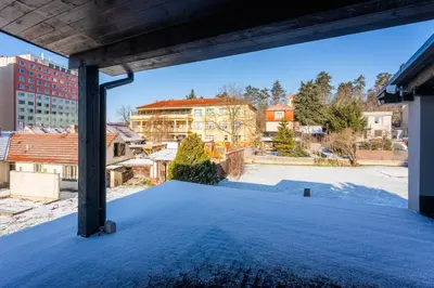 a view from the roof of a building with snow on the ground at Apartmány Modřany in Prague