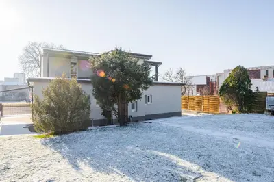 a house with a tree in the driveway at Apartmány Modřany in Prague