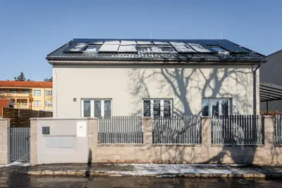 a house with solar panels on the roof at Apartmány Modřany in Prague