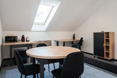 a room with a table and chairs and a window at Apartmány Modřany in Prague