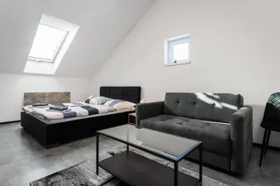 a living room with a couch and a coffee table at Apartmány Modřany in Prague