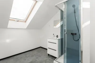 a bathroom with a glass shower and a sink at Apartmány Modřany in Prague