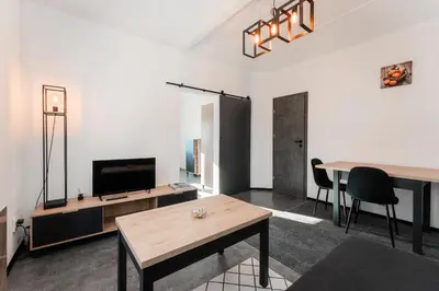 a living room with a table and a television at Apartmán Praha in Prague