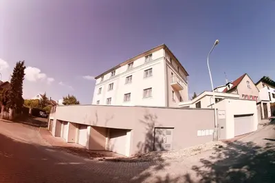 a white building on the side of a street at Villa na Vinici in Prague