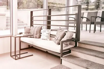 a metal bunk bed with pillows on a porch at Villa na Vinici in Prague