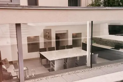 a dining table and chairs are seen through a window at Villa na Vinici in Prague
