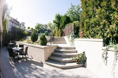 a patio with stairs and a table and chairs at Villa na Vinici in Prague
