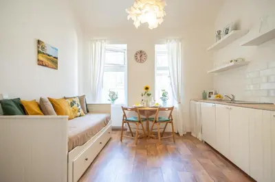 a living room with a couch and a table at Nice room with double bed in zizkov - shared bathroom in Prague