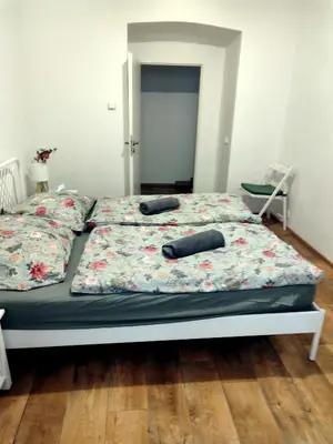 a bed with two pillows on it in a bedroom at Nice room with double bed in zizkov - shared bathroom in Prague