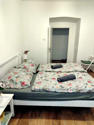 a bed with two pillows on top of it at Nice room with double bed in zizkov - shared bathroom in Prague