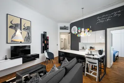 a kitchen and living room with a couch and a table at MOOo Downtown in Prague