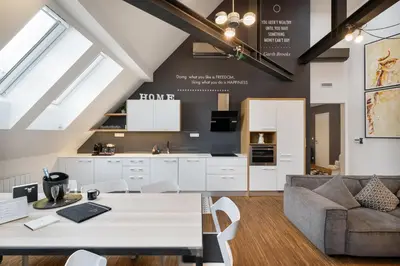 a kitchen and living room with a table and a couch at MOOo Downtown in Prague
