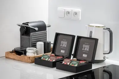 a counter with two boxes of coffee and a blender at MOOo Downtown in Prague