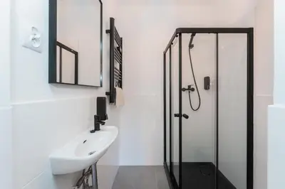 a bathroom with a sink and a shower at Apartmány Praha-Modřany in Prague