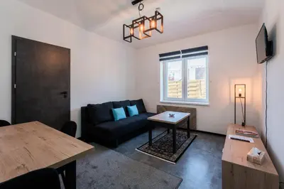 a living room with a couch and a table at Apartmány Praha-Modřany in Prague