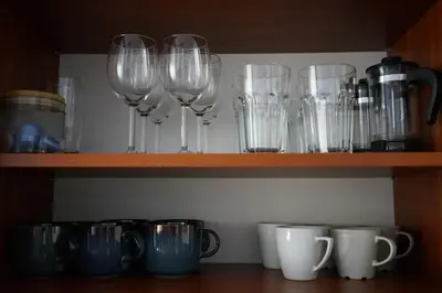 a row of wine glasses on a shelf at K-14 Apartment in Prague