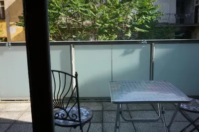 a chair and a table on a balcony at K-14 Apartment in Prague