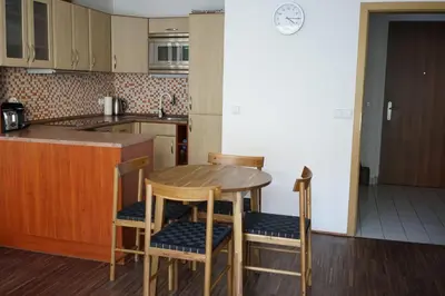 a kitchen with a wooden table and chairs in it at K-14 Apartment in Prague