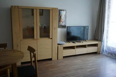 a living room with a entertainment center with a television at K-14 Apartment in Prague