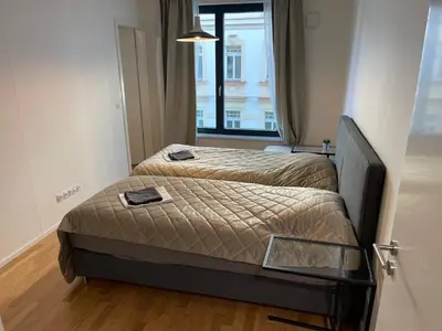 two beds in a small room with a window at Apartment 4 Room, 2 Bath, Parking in Prague