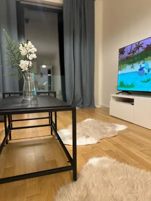 a living room with a vase of flowers on a table at Apartment 4 Room, 2 Bath, Parking in Prague