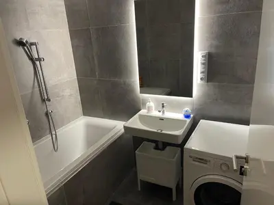 a bathroom with a sink and a toilet and a tub at Apartment 4 Room, 2 Bath, Parking in Prague