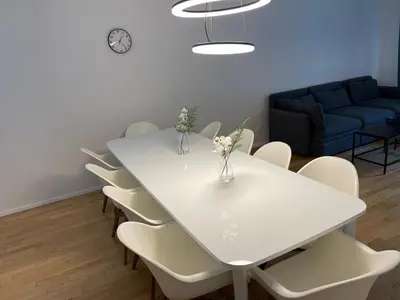 a white table with white chairs and a blue couch at Apartment 4 Room, 2 Bath, Parking in Prague
