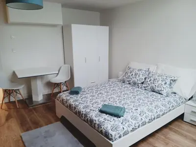 a small bedroom with a bed and a desk at Apartment Prague city center - next to Florenc in Prague