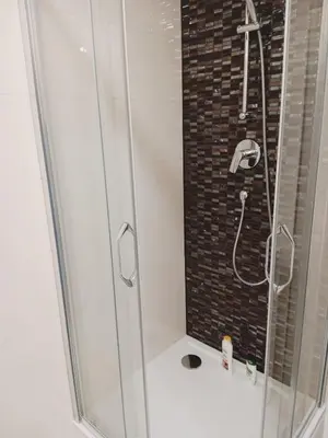 a shower with a glass door in a bathroom at Apartment Prague city center - next to Florenc in Prague
