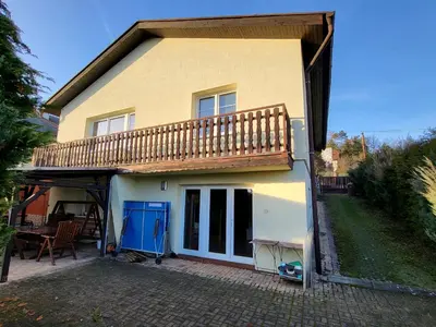 a house with a balcony and a patio at Ubytování na kopečku in Beroun